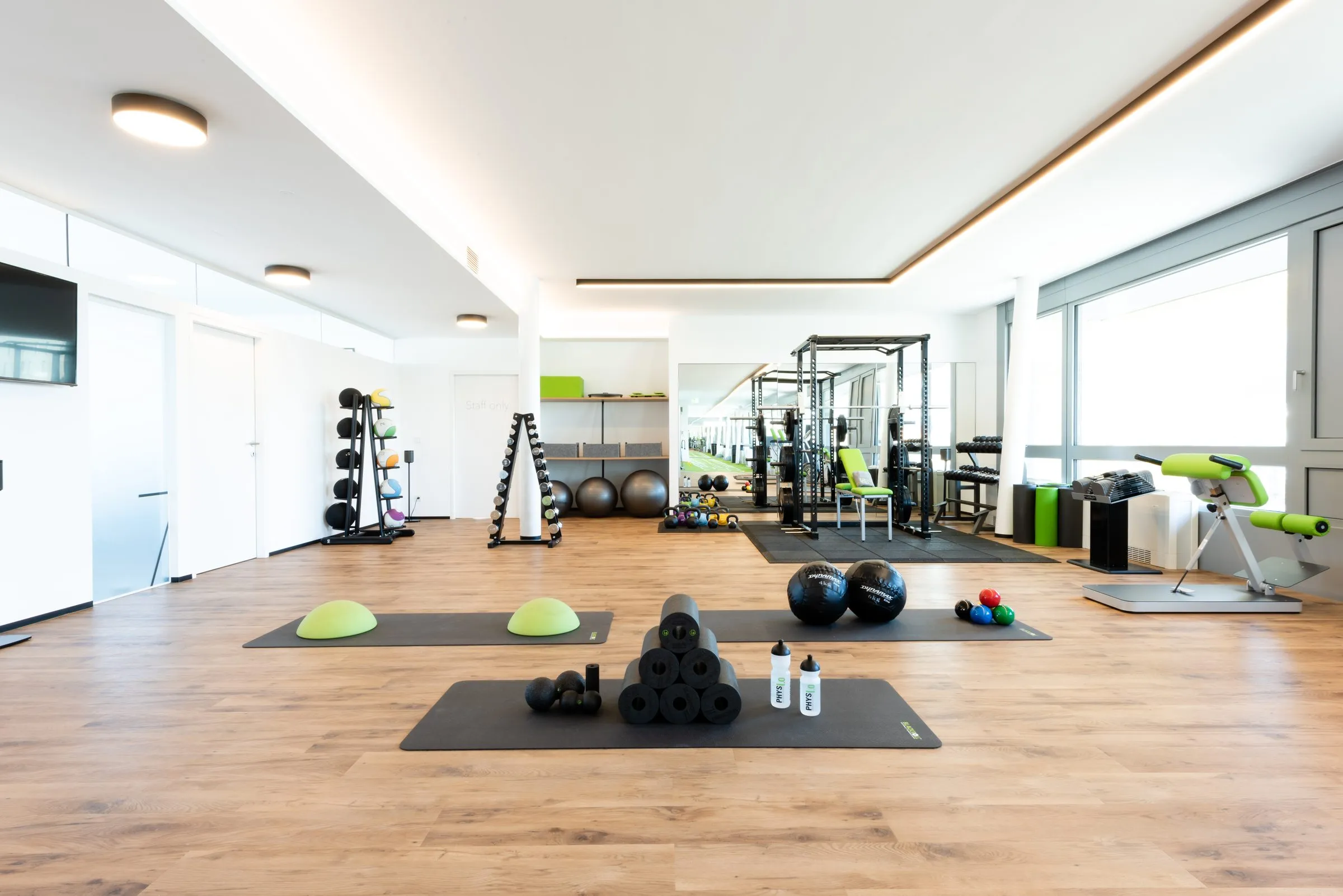 Bright training area at the practice in Innsbruck with equipment along the windows