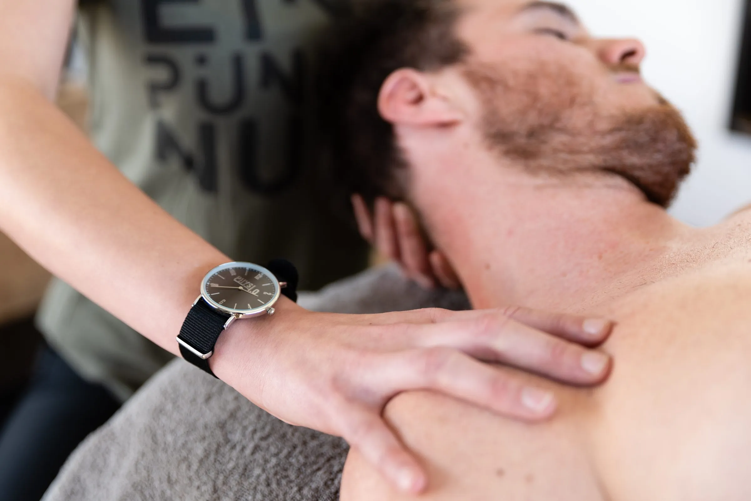 A therapist’s hands on a patient’s neck