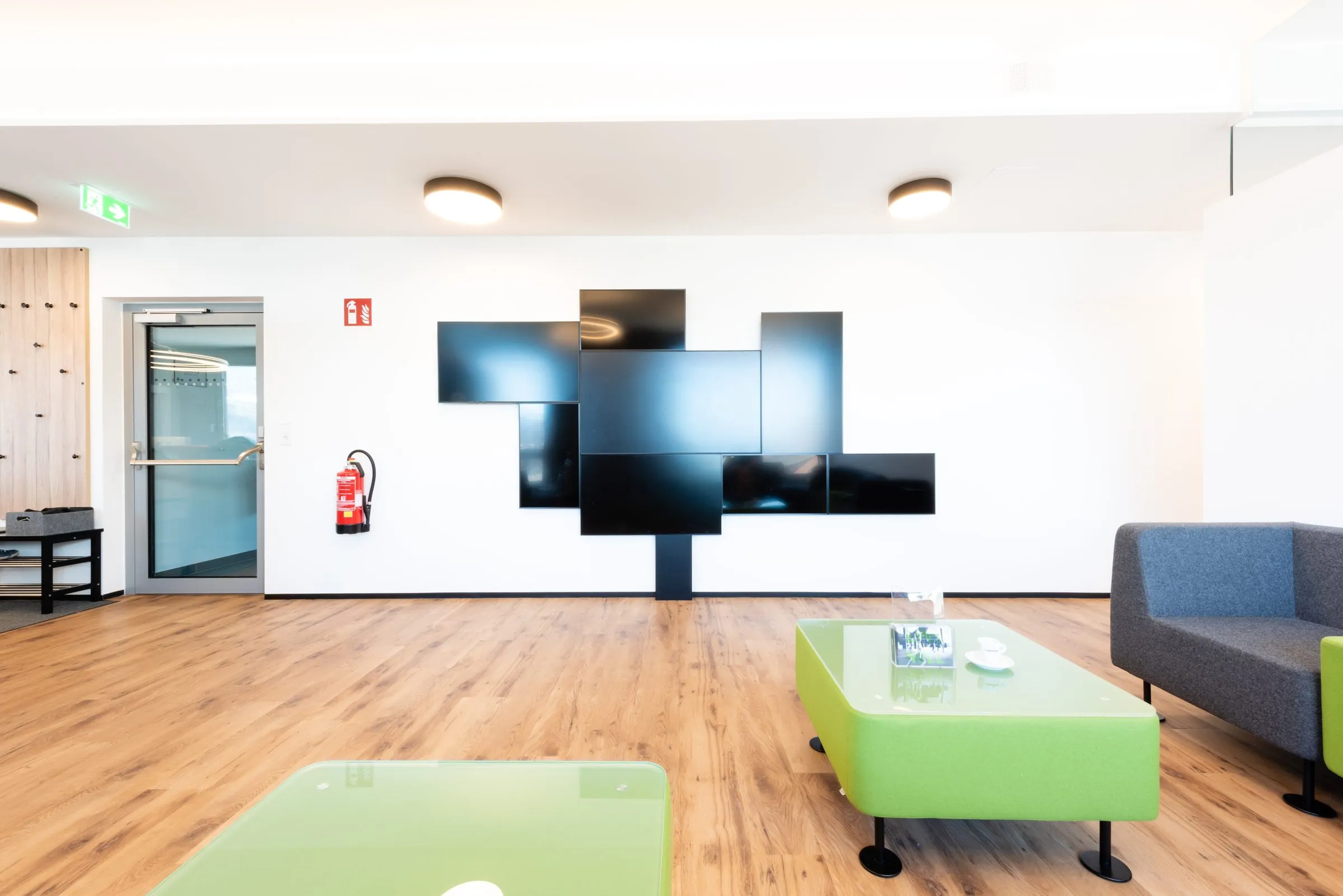 Waiting area of the practice with a green table and sofa