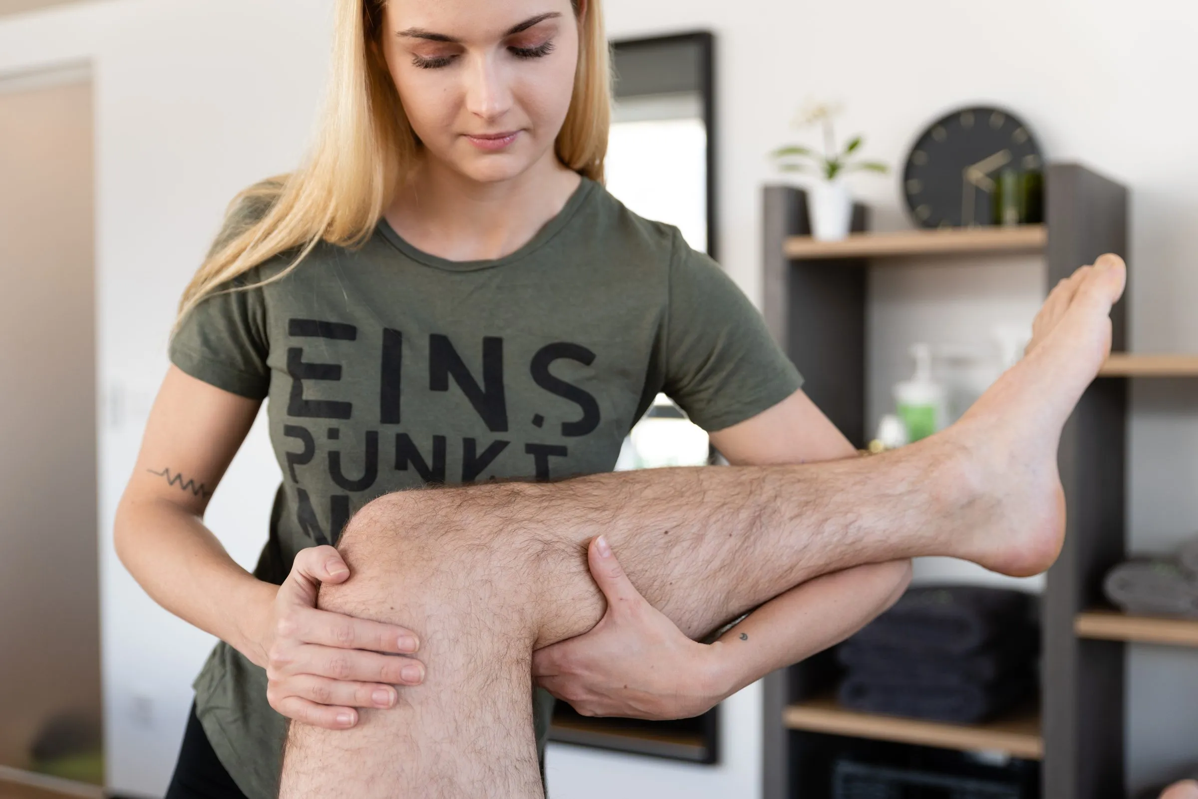 Physiotherapist mobilising a patient’s knee on the treatment table