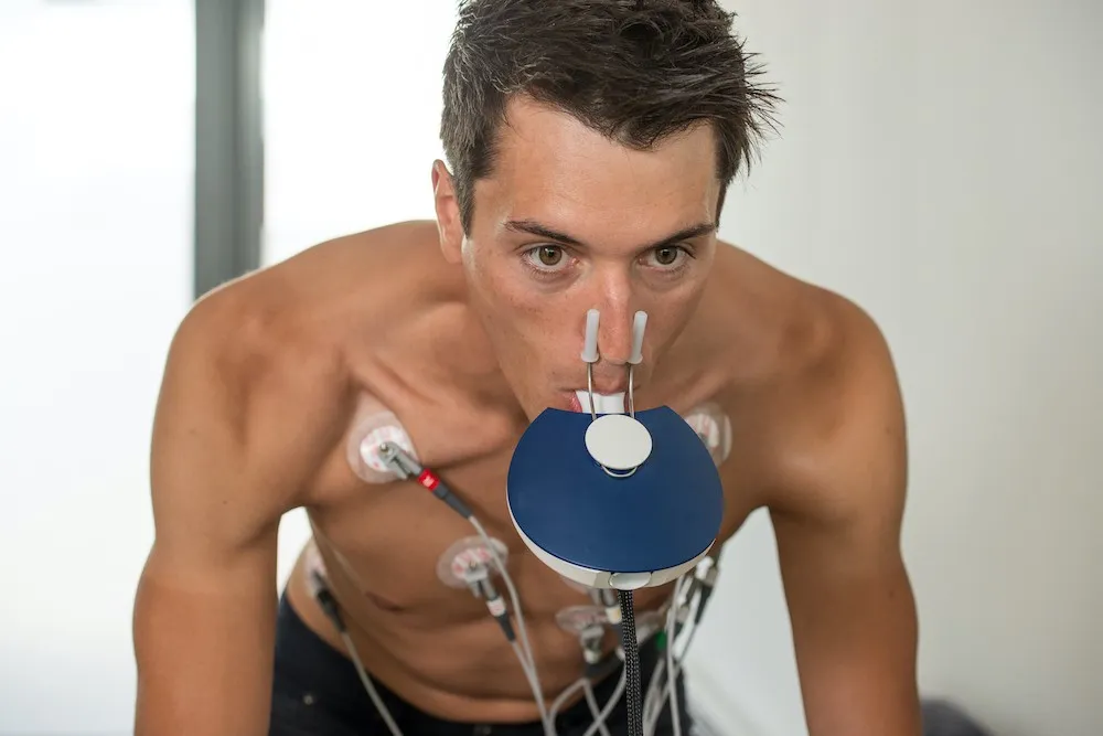 Athlete with a breathing mask and ECG electrodes during cardiopulmonary exercise testing